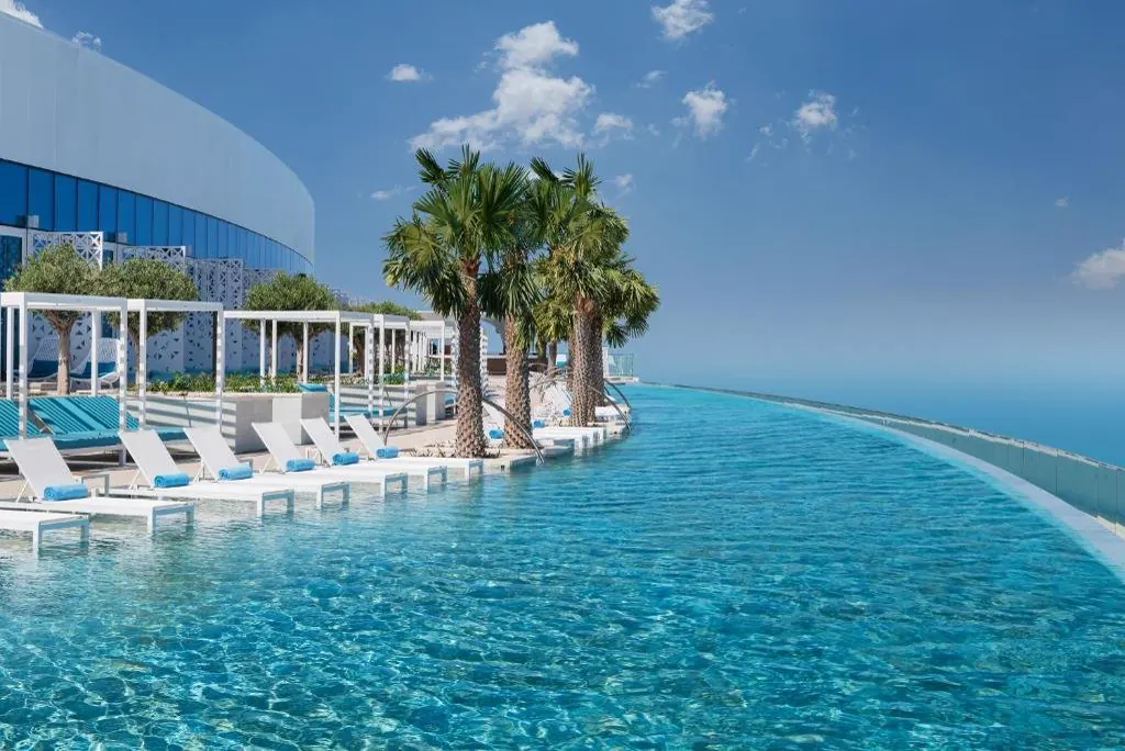 The infinity pool with white loungers
