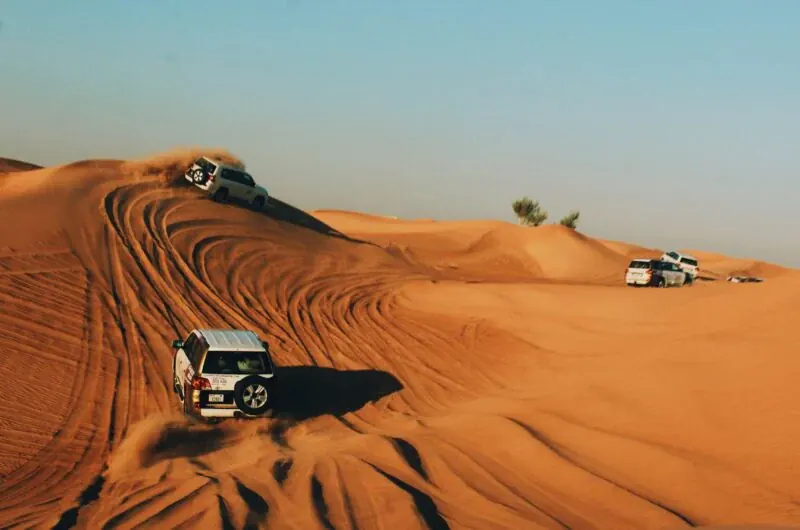 4x4 vehicles crossing red dunes